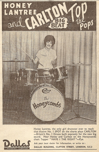 Honey Lantree seated at her customised drum kit from Carlton Drums, as shown in a clipping from the NME 1964.